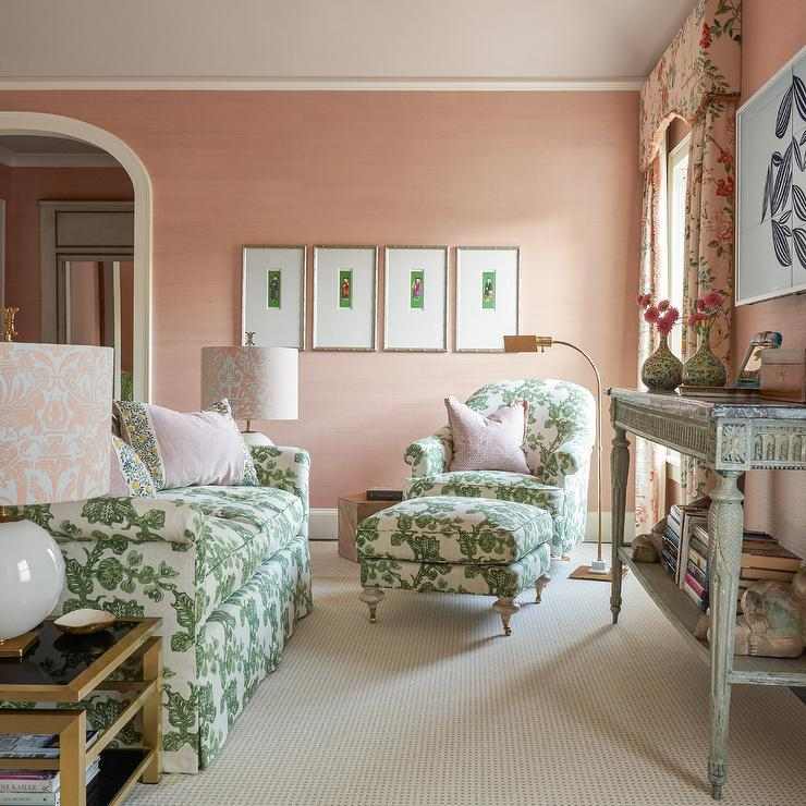 A green and pink chair in bedroom and wooden floor and frames on the wall