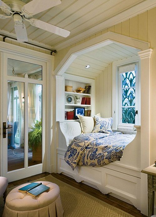 A cozy bed nook in bedroom with windows and rug on the floor