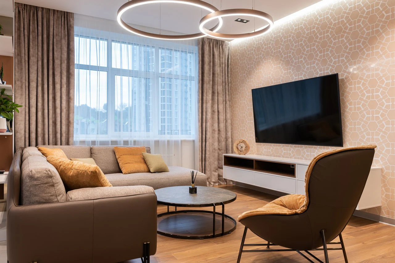 A tv on the design wall and sofa and table and wooden floor