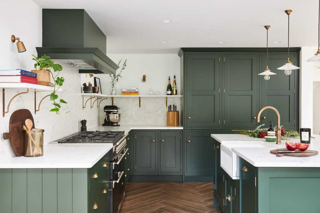 A green kitchen with white slap and fixtures