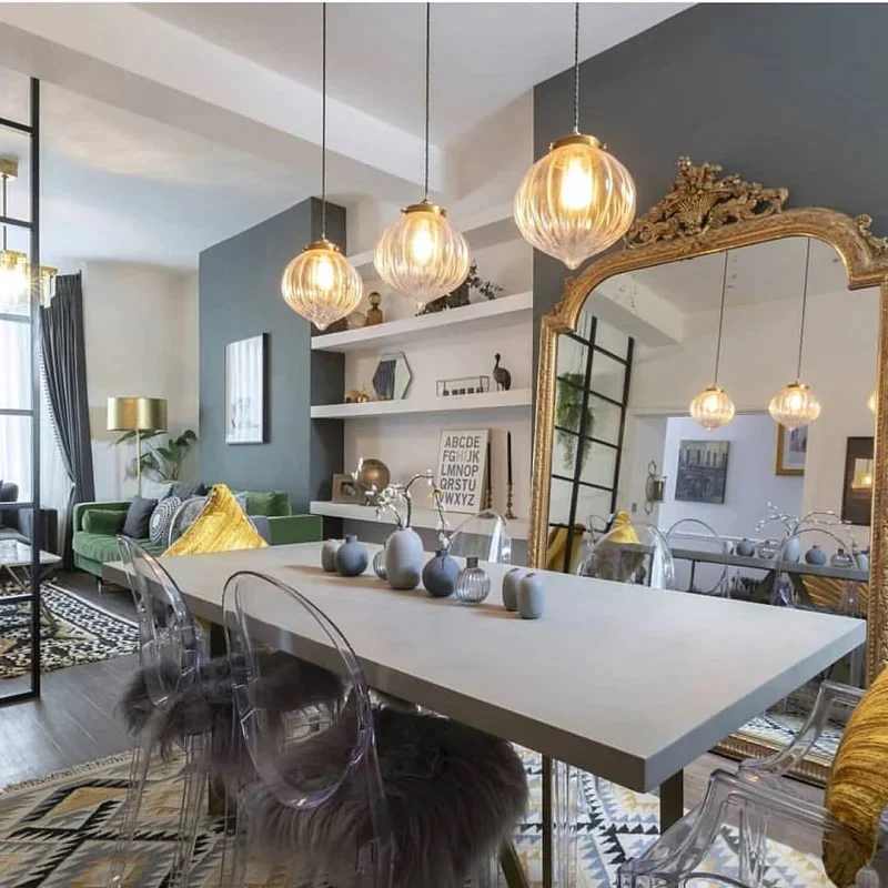 A small living room with dinning room with above lights on it