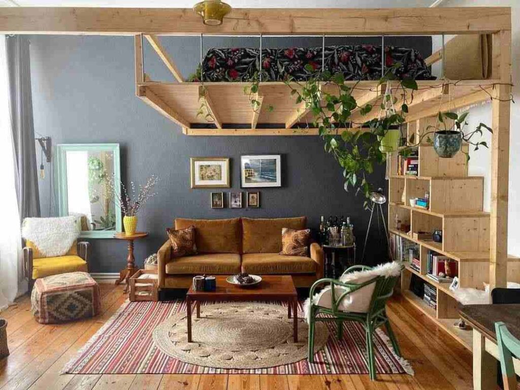 A room with floating loft bed and sofa with table and wooden shelves