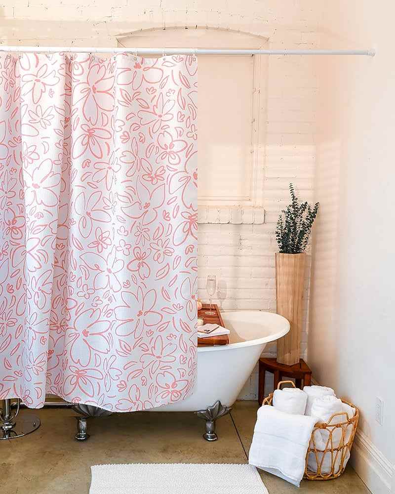 A bathroom with floral shower curtain and baskets on the wooden floor 