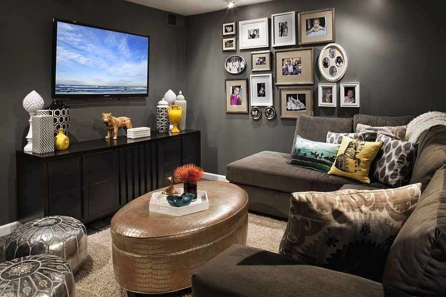 A small living room with table and frames on the wall