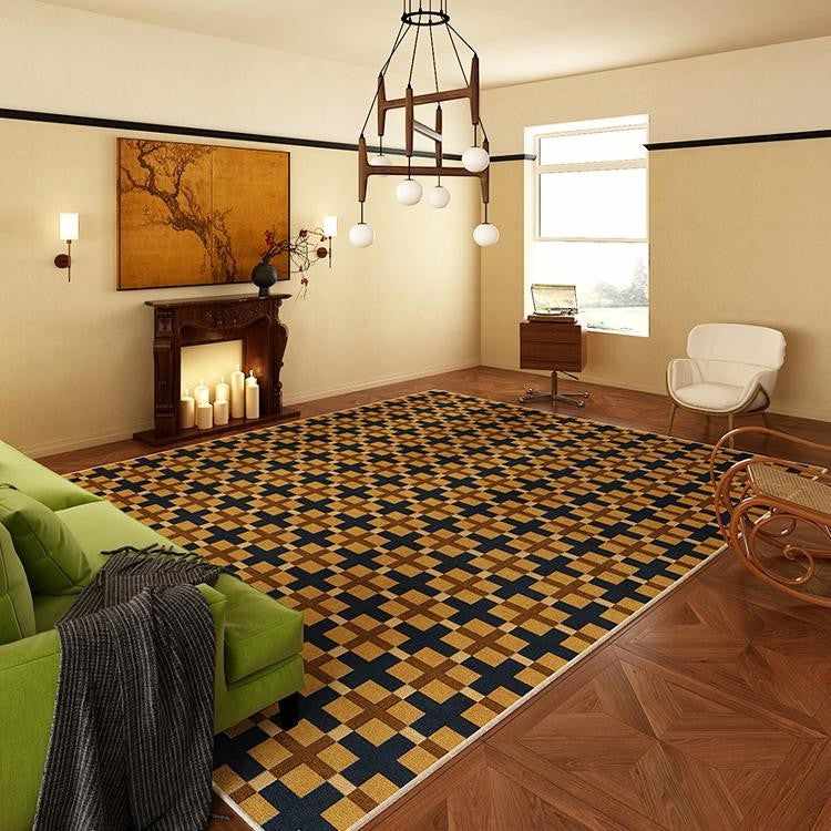 A living room with geometric rug on wooden floor and lamp on the wall