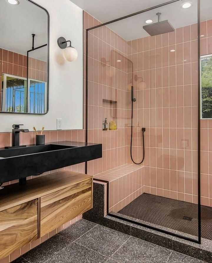 A bathroom with glass door and subway tiles