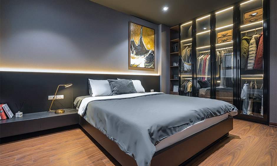 A bedroom with glass wardrobe wooden floor 