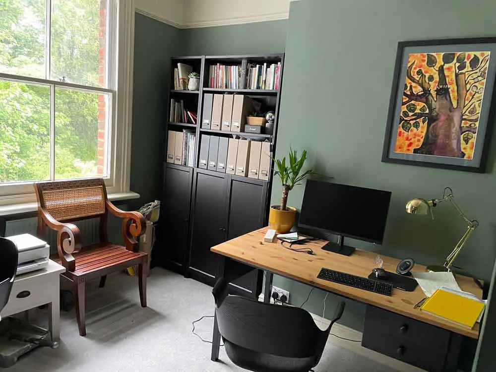 A green office with wooden table and chair