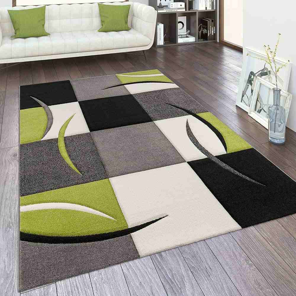 A living room with rug on the floor and wooden floor