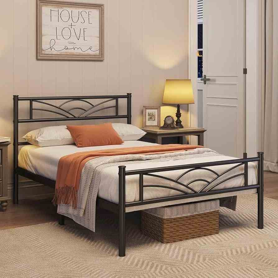 Iron framed bed with side table and lamp on it