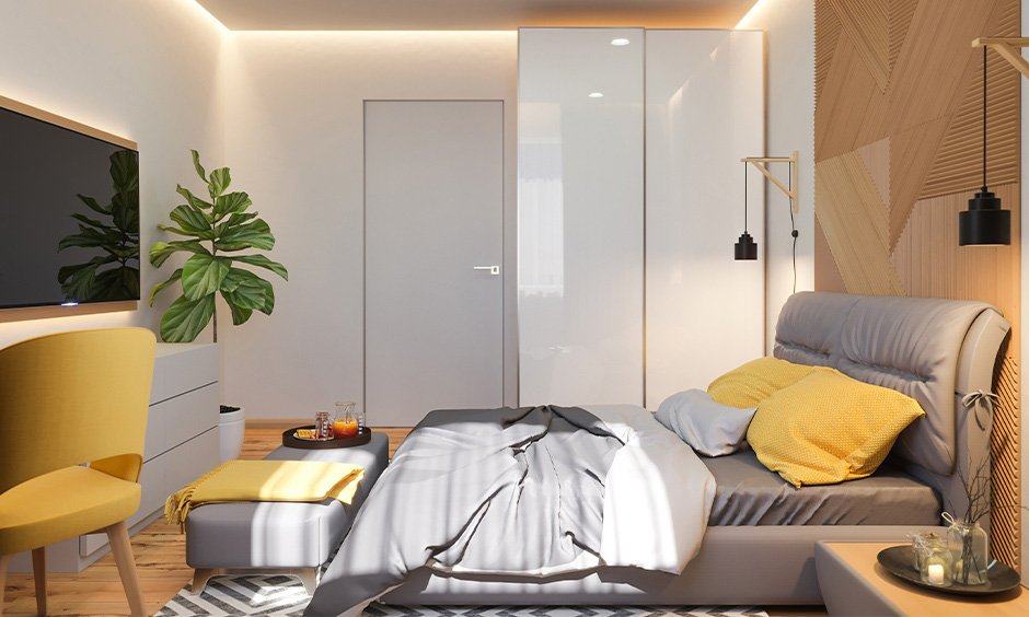 A bedroom with lighting fixture and wooden floor