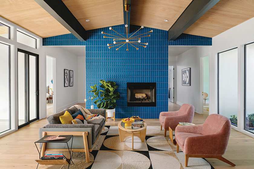 A modern living room with wooden celling and metallic lights