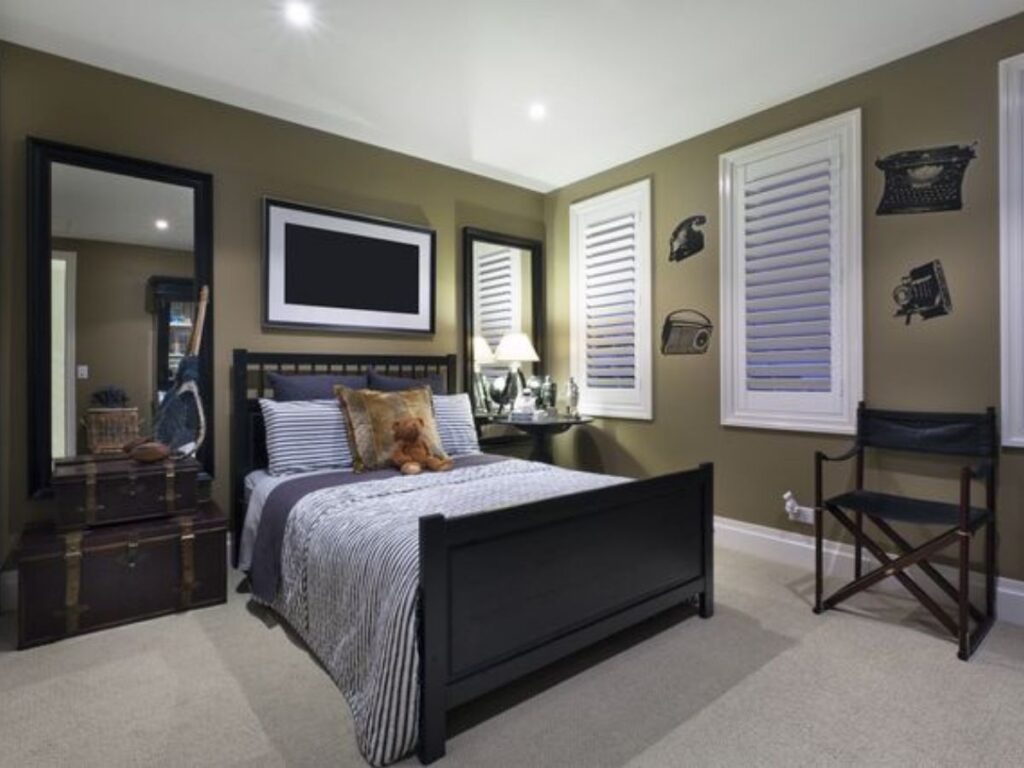 A bedroom with black framed mirror