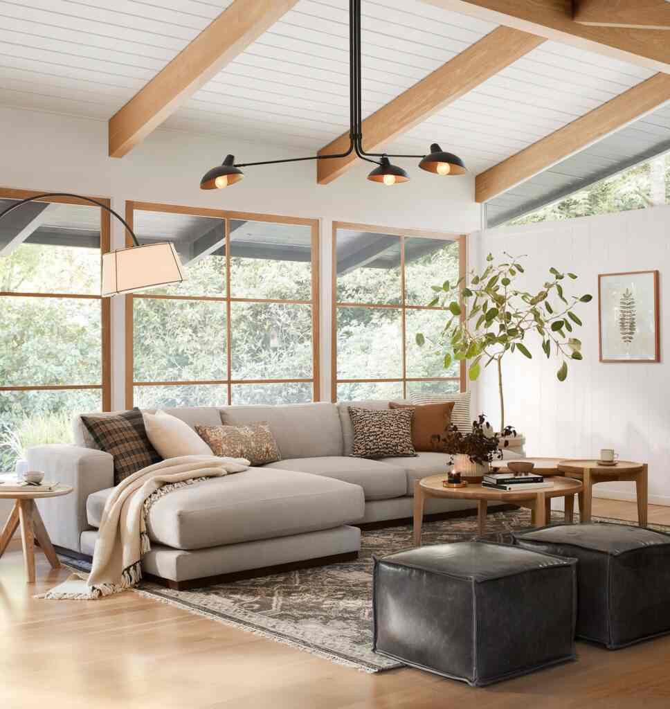 A living room with windows and plants and woden floor