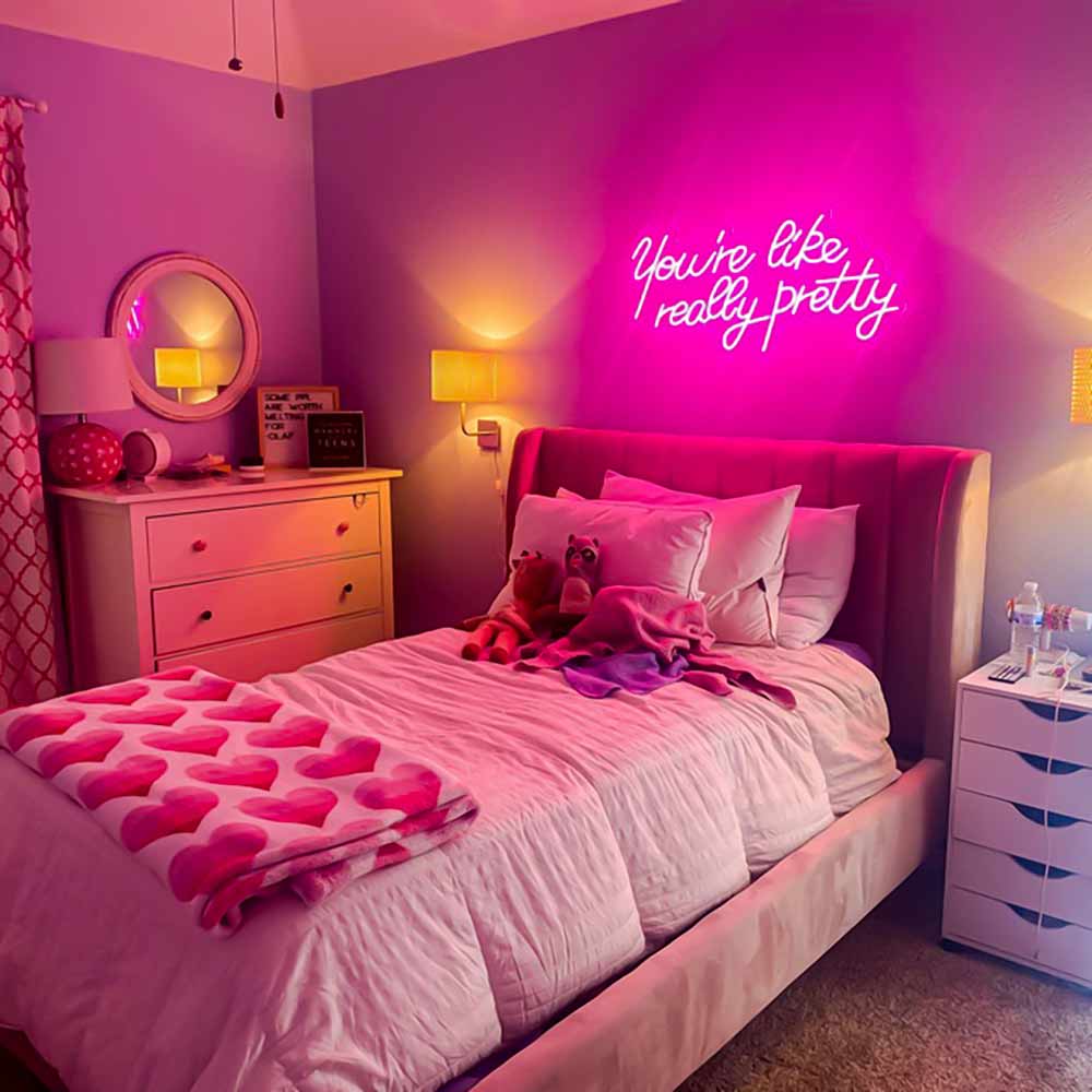 A bedroom with wooden deck and neon signs