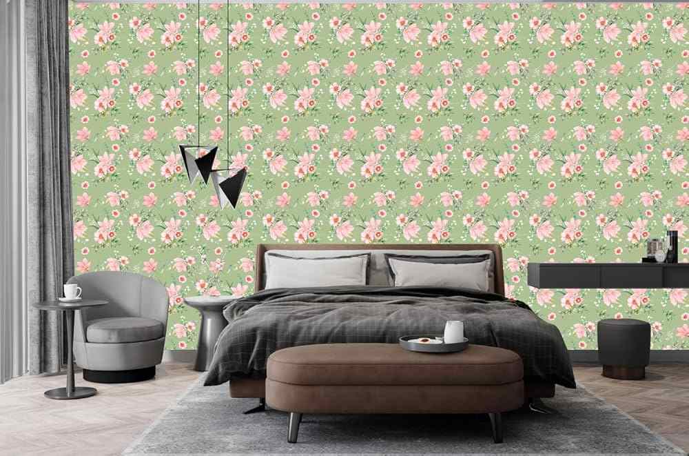 A bedroom with green and pink floral wallpaper