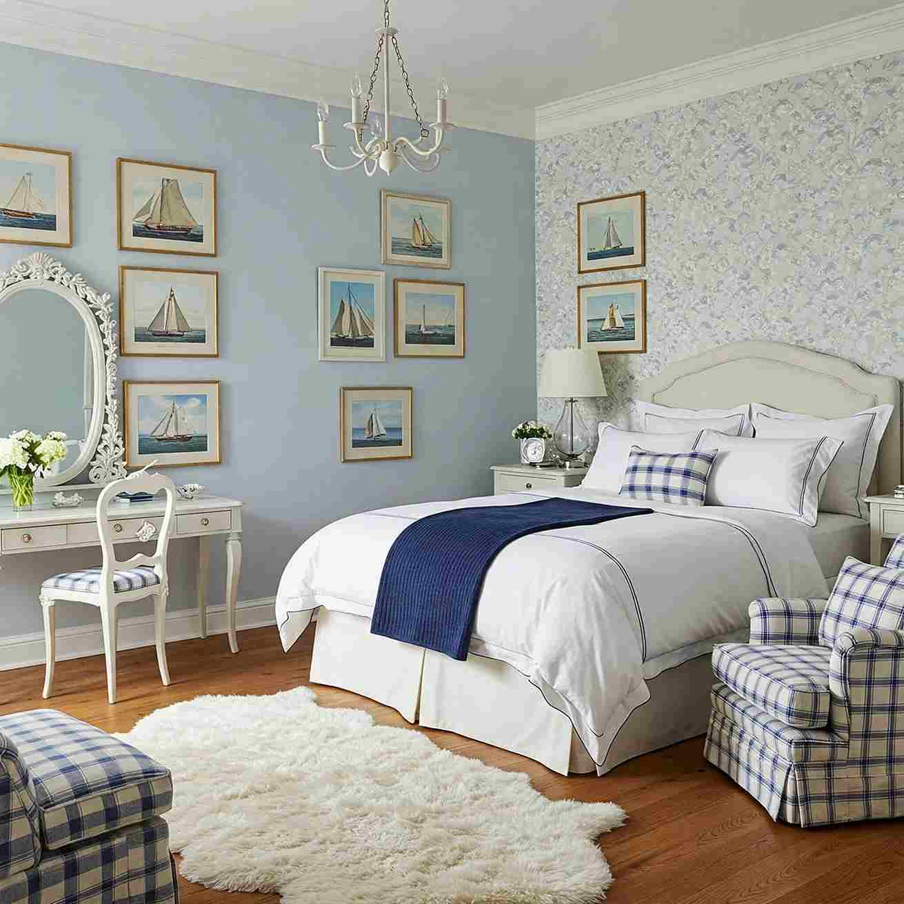 A bedroom with posh pattern and rug on wooden floor and white dresser in the room