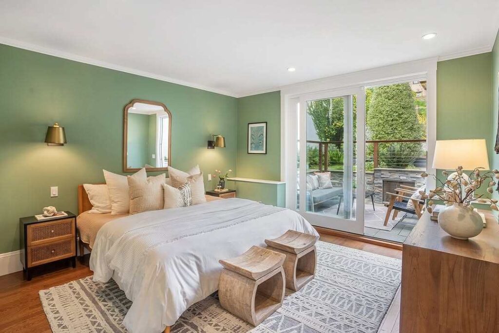 Sage green with bedroom with bed and cushion and wooden floor 