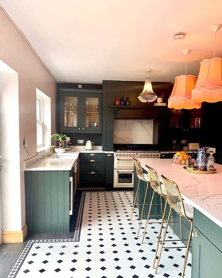 A kitchen and white and black accents and lights above the wall