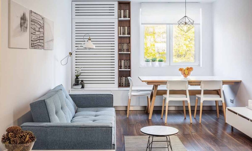 A small living room with slide-out dining and built shelves