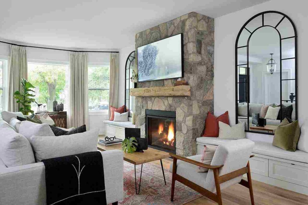 A small living room with mirror and sofa and wooden table and floor