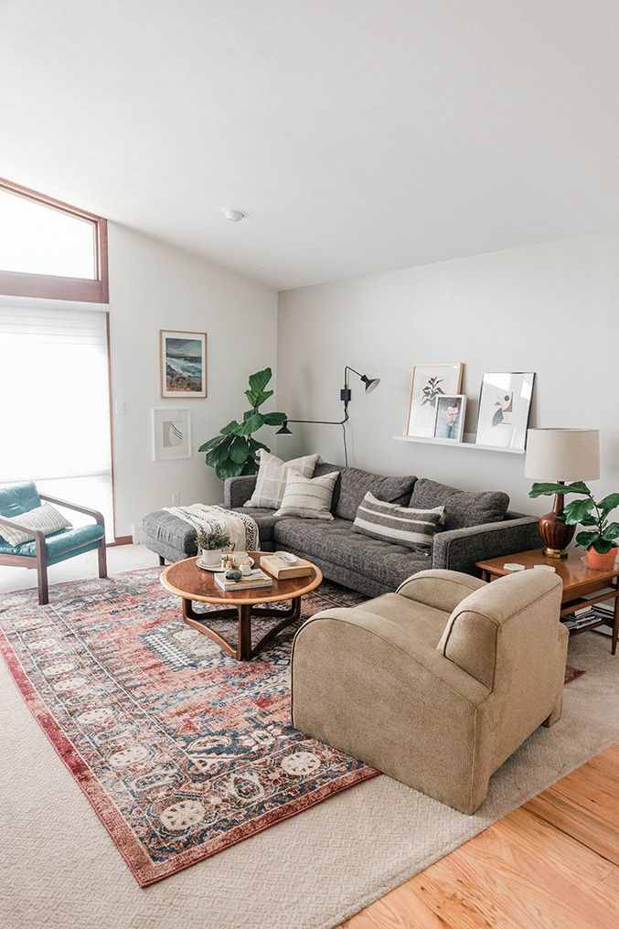 A small living room with rug on the floor