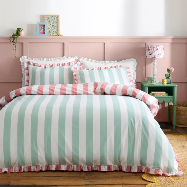A bedroom with pink and pink strip and wooden floor