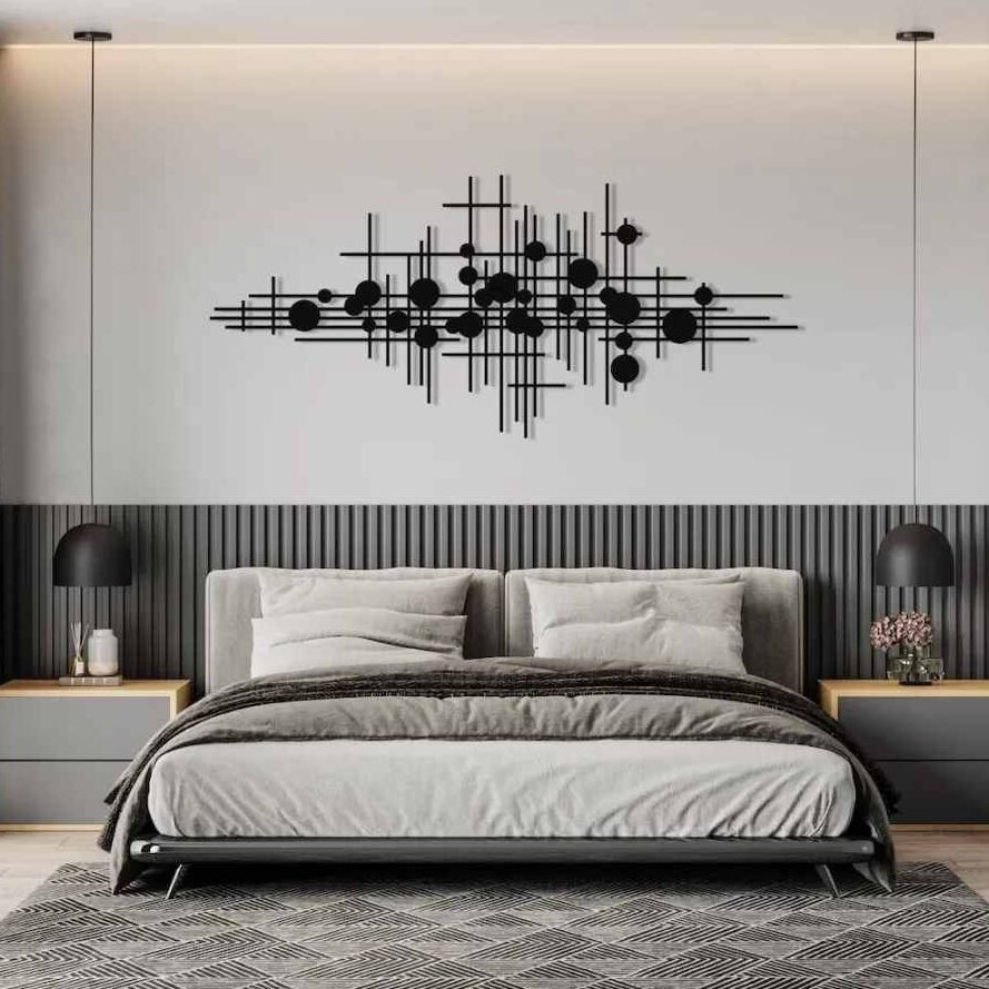 A bedroom with wall art on the wall and side table