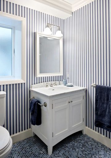 A blue and white strips wall in bathroom 
