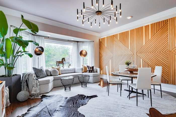 A living room with wooden wall and sofa and black table