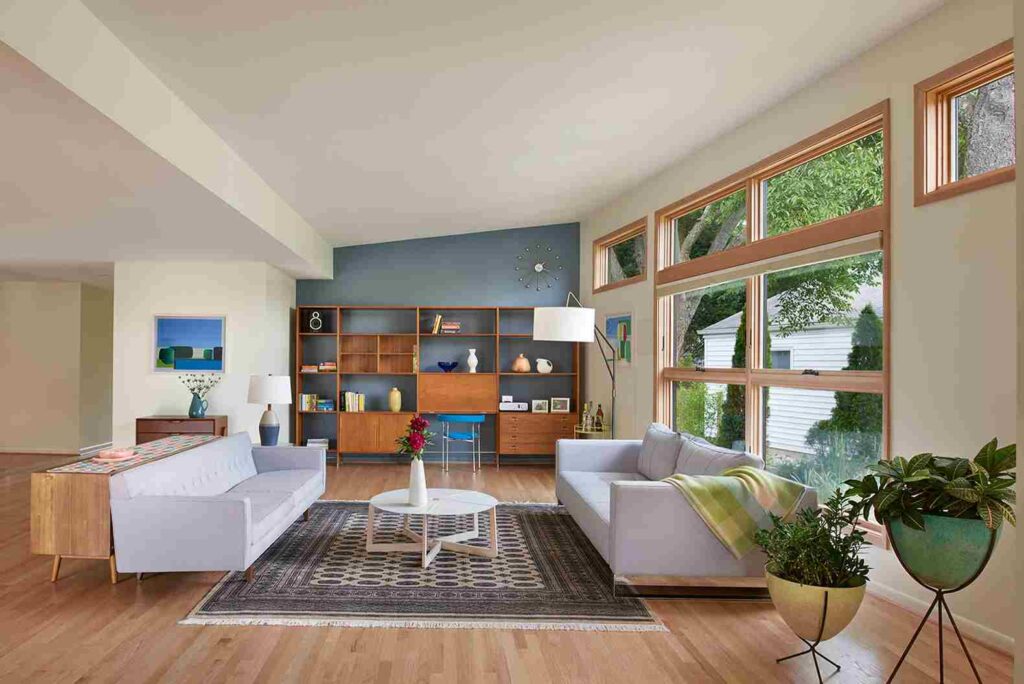 A mid century living room wooden floor and wooden framed windows