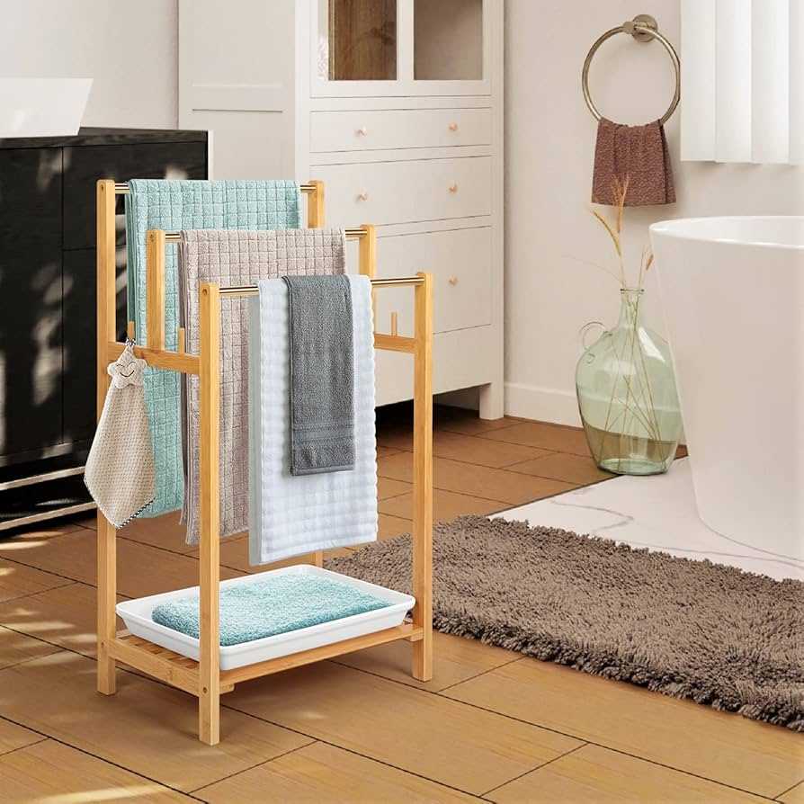A bathroom with wooden ladder as towel rack. and wooden floor 