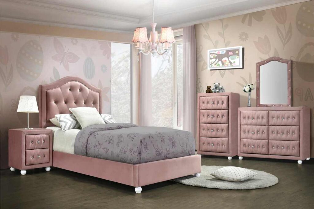A pink bedroom with pink mirror dresser and wooden floor and pink bedding with grey accents
