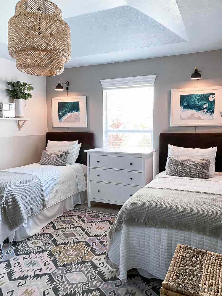 A bedroom with rug on the floor and lights on the wall 