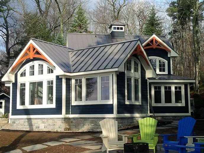 A navy blue house with black metal roof