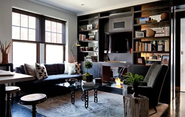 A black and white living room with Built-in shelving for display 