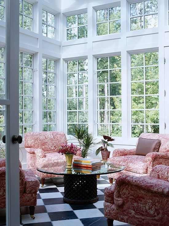 A glass windows and pink sofa and black and white floor 