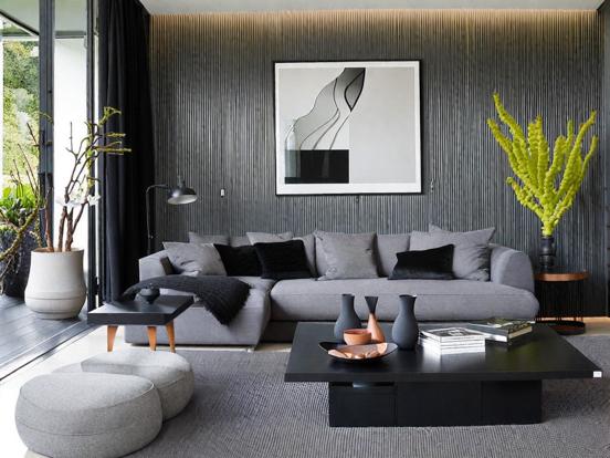 A grey living room with grey artwork on the wall 