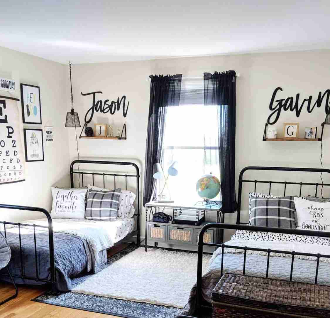 A bedroom with twins bed and Customized with names on the wall 