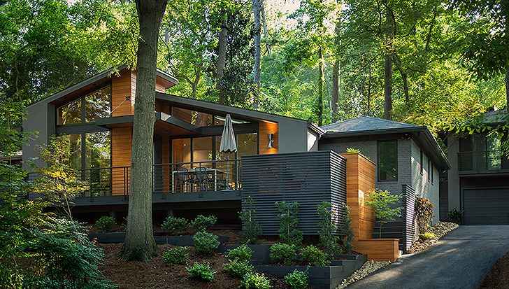 A green house with wooden accents