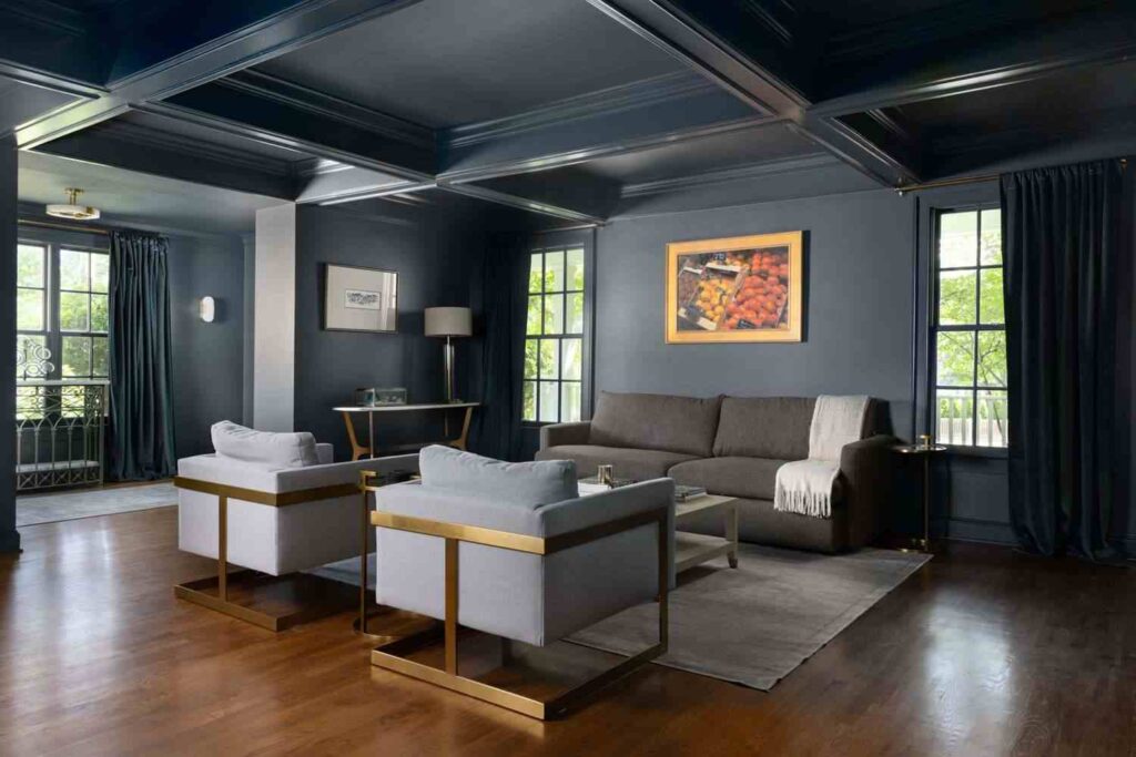 A grey wall with wooden floor and sofa table 