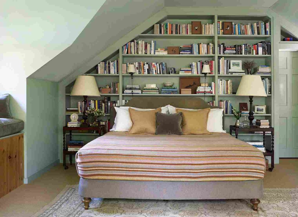 A sage green bedroom with shelves and wooden floor and rug on it