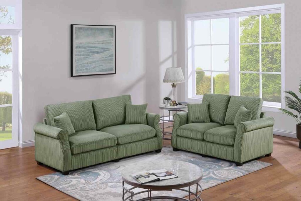 A grey living room with sage green sofa and rug on the wooden floor 