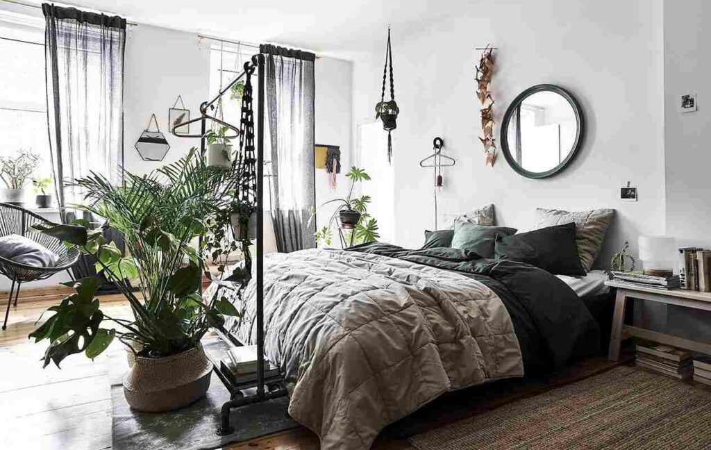 A bedroom with bed and plants and mirror on the wall 