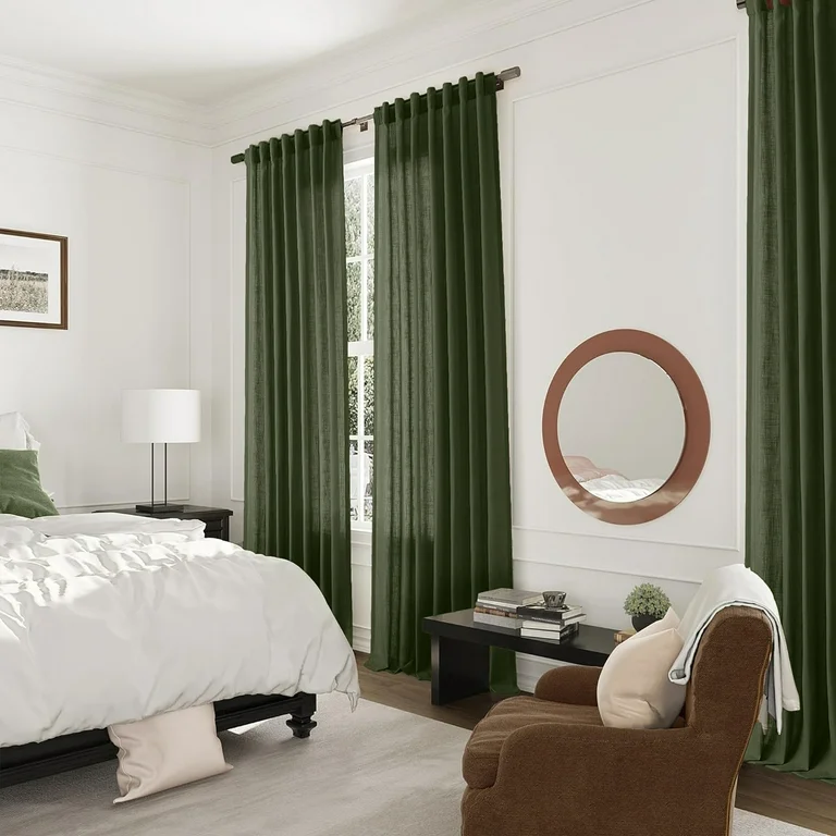 A bedroom with olive curtains and wooden floor and rug on it 