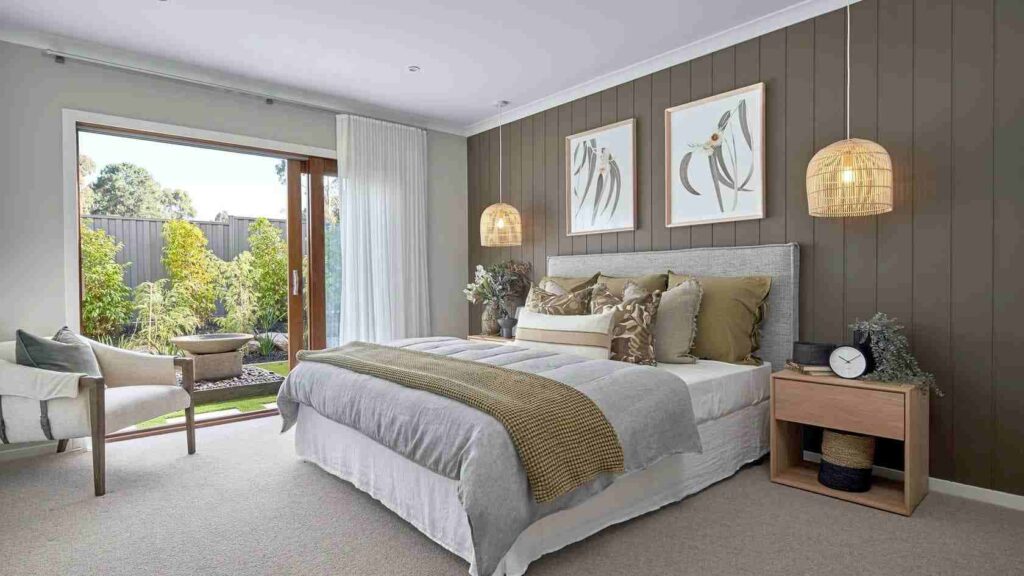 A bedroom with white celling and sidling door and chair and wall art on the wall 