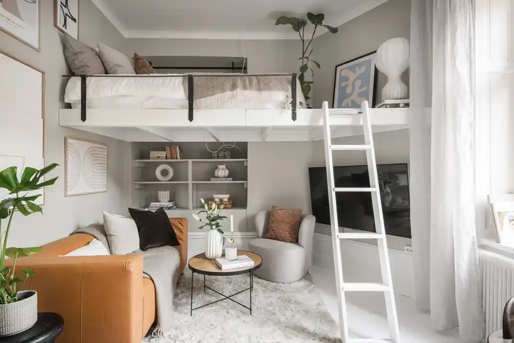 A loft bed with stair and sitting area and wooden floor 