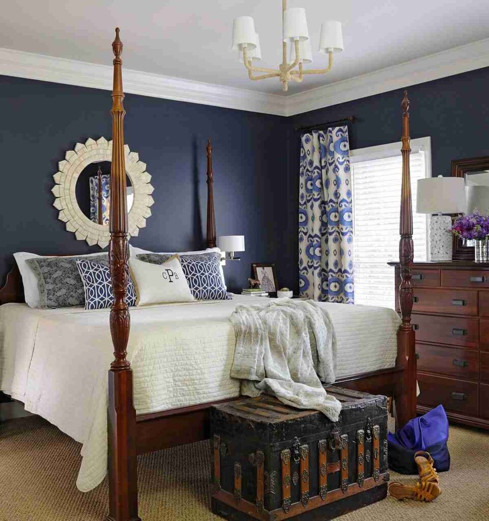 A blue and white bedroom with trim and wooden bed and windows