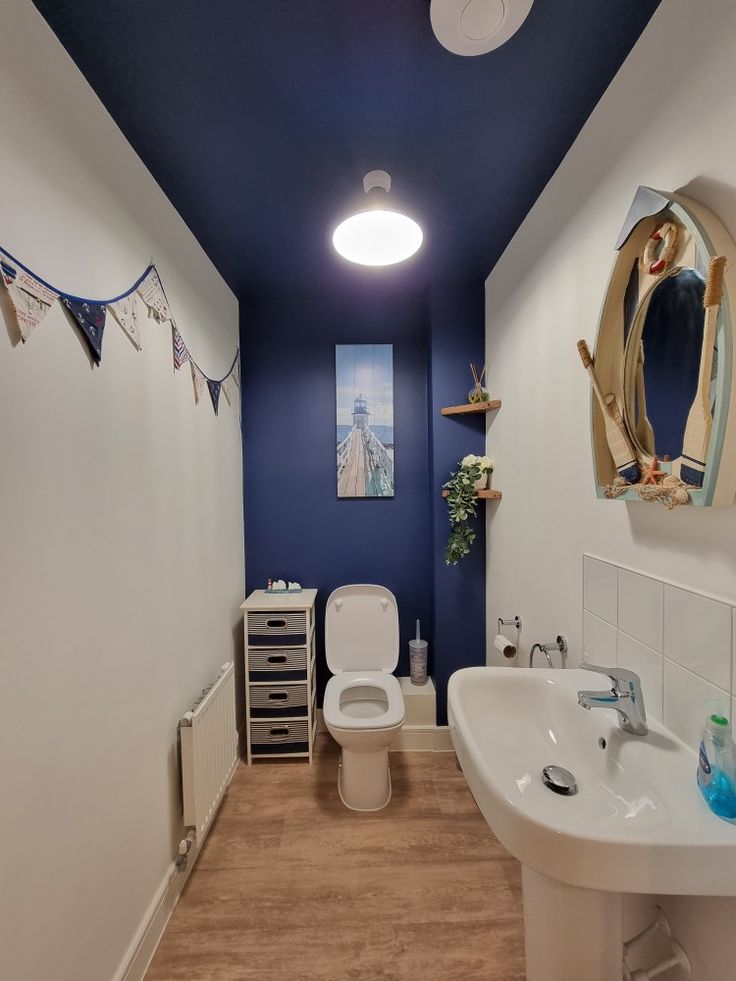 A navy blue celling with white walls and wooden floor