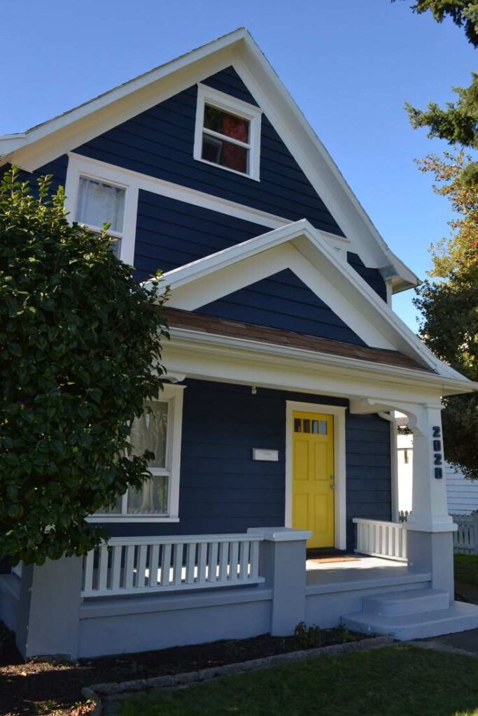 A navy blue with white trim and yellow door